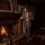 Male model standing near the fireplace with a Miliari Cigars Limited Edition
